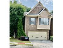 Charming two-story home featuring brick and siding, with a two-car garage and landscaped yard at 2691 Pointcrest Way, Grayson, GA 30017