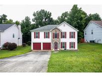 Charming two-story home featuring a two-car garage, stone accents, and red shutters at 620 River Mist Dr, Jonesboro, GA 30238