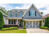 Charming two-story home featuring a well-manicured lawn, beautiful landscaping and a gray accent garage at 1282 Kendrick Ne Rd, Brookhaven, GA 30319