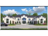 Stunning exterior elevation of a luxury home showcasing architectural details and a large driveway at 4309 Giverney Blvd, Fairburn, GA 30213