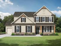 Charming two-story home with neutral siding, dark shutters, and a well-manicured lawn at 1313 Pj East Rd, Covington, GA 30014