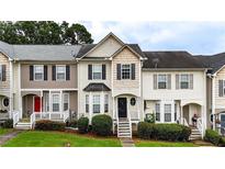 Charming townhome featuring manicured lawn, black shutters, bay window and inviting front porch at 88 Timber Ridge Dr, Cartersville, GA 30121