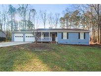 Charming single-story home with a well-maintained lawn and attached two-car garage at 1403 W Prospect Dr, Lawrenceville, GA 30043