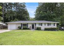 Charming single-story brick home with a well-manicured front lawn and mature trees in a quiet neighborhood at 2292 Country Club Sw Ln, Atlanta, GA 30311