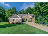 Charming two-story home with landscaped front yard and inviting stone accents at 4252 Keheley Lake Dr, Marietta, GA 30066