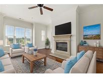Bright living room with a fireplace, large windows, and comfortable seating arrangement at 3635 E Paces Ne Cir # 1405, Atlanta, GA 30326