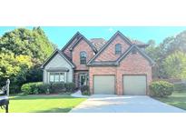 Charming two-story brick home featuring a two-car garage and well-manicured landscaping at 532 Mount Gerizim Se Rd, Mableton, GA 30126