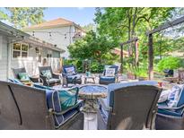Inviting backyard patio with a stone fire pit and comfortable seating, perfect for outdoor entertaining and relaxation at 6077 Lake Lanier Heights Rd, Buford, GA 30518