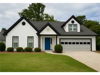 Charming one-story home with a well-manicured lawn and a striking blue front door at 810 Doe Hill Ln, Roswell, GA 30075