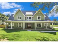 Charming two-story home featuring a large, inviting front porch and well-manicured lawn at 529 Claude Scott Rd, Canton, GA 30115