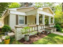 Charming brick home featuring a welcoming front porch with elegant columns and well-manicured landscaping at 1104 Victory Sw Dr, Atlanta, GA 30310