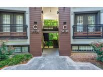 Two-story apartment building featuring wood trim and balconies with iron railings at 1445 Monroe Ne Dr # C32, Atlanta, GA 30324