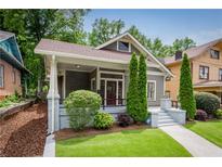 Charming craftsman home with a well-manicured lawn, lovely landscaping, and inviting front porch at 1232 Lucile Sw Ave, Atlanta, GA 30310