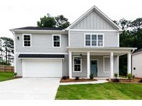Charming two-story home with gray siding, manicured lawn, and attached two-car garage at 2561 Adair Ridge Ct, Decatur, GA 30034