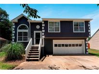 Charming two-story home featuring a front-facing garage and a welcoming entrance with a stairway and porch at 3620 Darwin Pl, Duluth, GA 30096