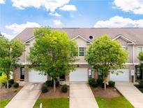 A charming townhome with a well-maintained lawn and driveway leading to the garage at 5843 Taka Ln, Lithonia, GA 30038