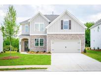 Charming two-story home with brick accents, a two-car garage, and a well-manicured lawn at 1731 Fulmont Cir, Mableton, GA 30126
