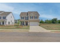 Traditional two-story home with neutral siding, black shutters, and a two-car garage at 568 Teversham Dr, Mcdonough, GA 30253