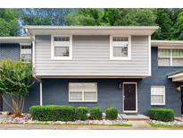 Inviting two-story townhome with a beautifully painted brick facade and lush landscaping at 3149 Buford Ne Hwy # 2, Atlanta, GA 30329