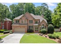 Beautiful brick two-story home with manicured lawn and mature trees in a desirable neighborhood at 5007 Highland Oaks Se Ct, Smyrna, GA 30126