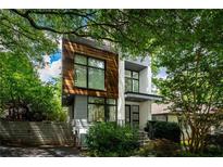 Contemporary home with wood and white exterior and manicured landscaping at 670 Willoughby Ne Way, Atlanta, GA 30312