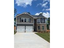 Charming two-story home featuring a two-car garage and stylish gray and brick facade at 746 Great Oak Pl, Villa Rica, GA 30180