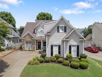 Charming two-story home with landscaped yard, stone accents, and a well-manicured lawn at 1472 Lynchburg Pl, Marietta, GA 30062