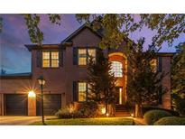 Beautiful two-story brick home with a well-manicured lawn and lush landscaping at 1701 Clay Brooke Se Ct, Smyrna, GA 30082