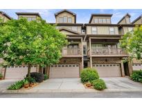 Charming townhome with brick accents, garage, and a balcony overlooking a landscaped yard at 3202 Saute Way, Avondale Estates, GA 30002
