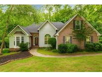 Charming home featuring a brick facade, bay window, and lush lawn at 733 Exchange Mill Pl, Dacula, GA 30019