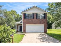 Charming two-story brick home with well-maintained lawn and attached two-car garage at 6595 Browns Mill Ferry Dr, Lithonia, GA 30038