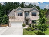 Charming two-story home with a well-manicured lawn and attached two-car garage at 302 Aspen Valley Ln, Dallas, GA 30157