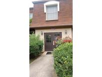 Charming exterior with a well-maintained entrance featuring a brown door and lush green shrubs at 80 Place Fontaine, Lithonia, GA 30038