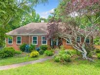 Charming one-story brick home with manicured lawn and mature landscaping at 2930 Heather Stone Way, Lawrenceville, GA 30043