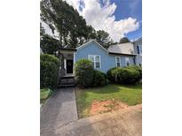 Charming single-Gathering home features a covered porch, lush landscaping, and a well-maintained lawn at 4059 Heritage Valley Ct, Norcross, GA 30093