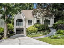 Charming painted-brick home boasts manicured landscaping, two-car garage, and a welcoming walkway at 1833 N Rock Springs Ne Rd, Atlanta, GA 30324