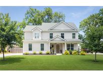 Charming two-story home with a manicured lawn and inviting front porch at 2486 Eastwood Dr, Atlanta, GA 30032