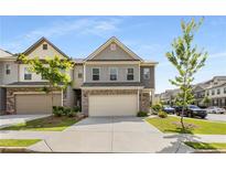 Charming townhome featuring a two-car garage, well-manicured lawn, and inviting curb appeal at 2829 Wild Laurel Ct, Norcross, GA 30071