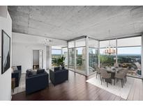 Bright open-concept living and dining area featuring hardwood floors and a stunning city view at 3324 Peachtree Ne Rd # 2718, Atlanta, GA 30326