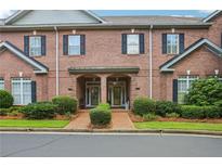 Charming brick townhome with a beautifully landscaped front yard and covered entryway at 1950 Buford Dam Rd # 205, Cumming, GA 30041
