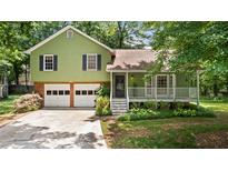 Charming two-story home with a brick foundation, a front porch, and a two-car garage at 3627 Spring Meadow Court, Acworth, GA 30101