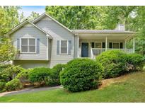 Charming single-story home with a covered front porch and well-maintained landscaping at 144 Wiley Dr, Douglasville, GA 30134