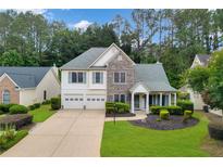 Charming two-story home with a two-car garage, stone accents, and a well-manicured lawn at 4206 Moccasin Trl, Woodstock, GA 30189