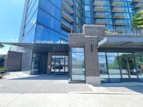Modern condominium building entrance with glass windows and brick accents at 788 W Marietta Nw St # 512, Atlanta, GA 30318
