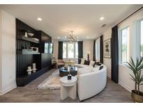 Bright living room features a curved sofa, decorative fireplace, and plenty of natural light at 392 Pratt Dr # 2014, Atlanta, GA 30315