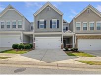 Charming townhome featuring a two-car garage, gray siding, and well-maintained landscaping at 36 Crescent, Dallas, GA 30157