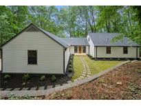 Charming renovated home featuring a landscaped front yard and stone walkway at 3710 Country Estate Dr Nw, Kennesaw, GA 30152