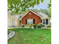 Charming home featuring a brick facade and well-maintained landscaping at 3064 Baymount Way, Lawrenceville, GA 30043