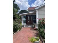 Charming home featuring a beautiful front door with decorative glass and a quaint, flower-lined walkway at 702 Moon Rd, Lawrenceville, GA 30046