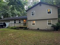 Charming two-story home featuring a combination of siding, complemented by a well-maintained lawn and natural landscaping at 3474 Leaf Land Ct, Duluth, GA 30097